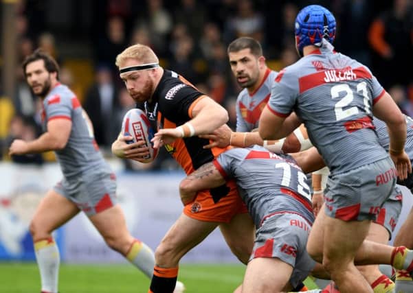 Two-try Oliver Holmes, of Castleford Tigers, is tackled by Mickael Simon, of Catalans Dragons. PIC: James Hardisty