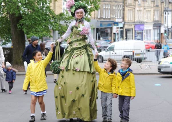 Miss Topiary (Rachel Hyde) of Chicks on Sticks pictured at last year's at Oakwood Day, with Isobel Pollock, eight, and brothers Arthur , five, and Archie, seven.