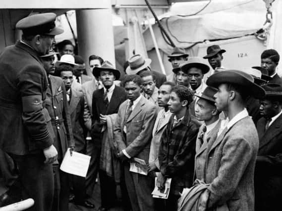 Jamaican immigrants being welcomed by RAF officials from the Colonial Office after the ex-troopship HMT "Empire Windrush" landed them at Tilbury in 1948.