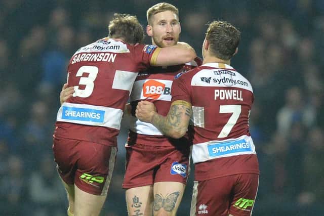 Wigan Warriors' Sam Tomkins  is congratulated on his drop goal.