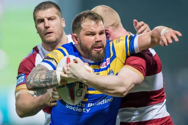 Adam Cuthbertson is tackled by Wigan's Tony Clubb and Liam Farrell.