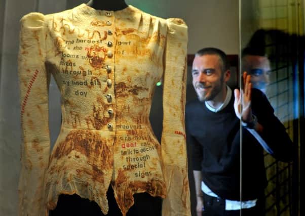 Curator Chris Sharp looks at a garment made by Chloe Greenwood named Hard Times,  part of the exhibition The Felted Mill, which is felt creations by local felters inspired by the Leeds Industrial Musuem, Armley Mill. Picture Tony Johnson.