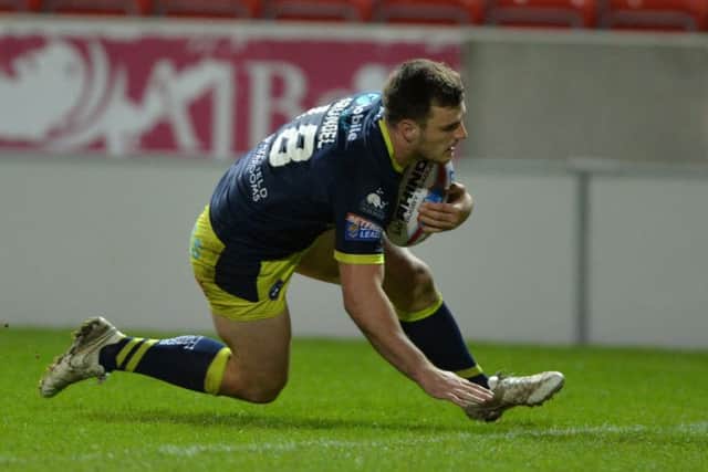 Joe Arundel scores Trinity's try.