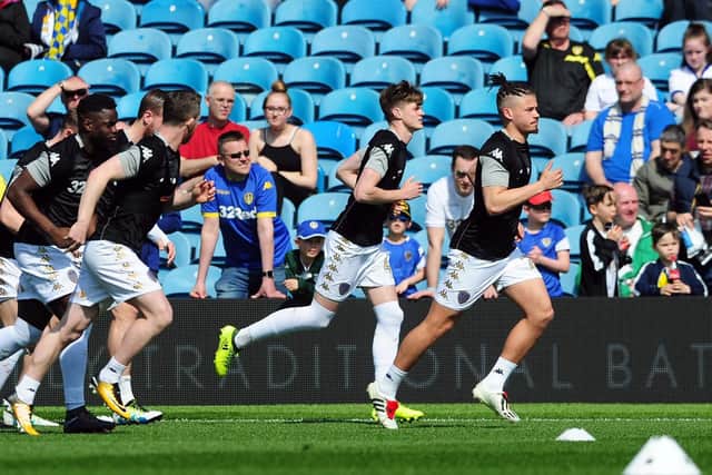 Kalvin Phillips, far right, and Tom Pearce lead the way as Leeds United warm up for today's clash with Barnsley.