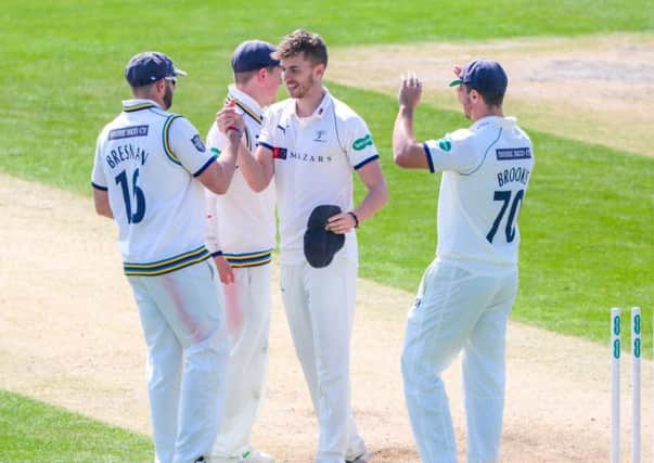 Yorkshire's Ben Coad is congratulated on the wicket of Notts' Harry Gurney on Saturday at Headingley. Picture: Alex Whitehead/SWpix.com