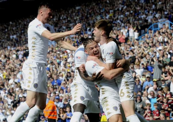 MOMENT TO SAVOUR: Leeds United's Tom Pearce is hugged by Kalvin Phillips after scoring his first goal for Leeds United. Picture by Simon Hulme.