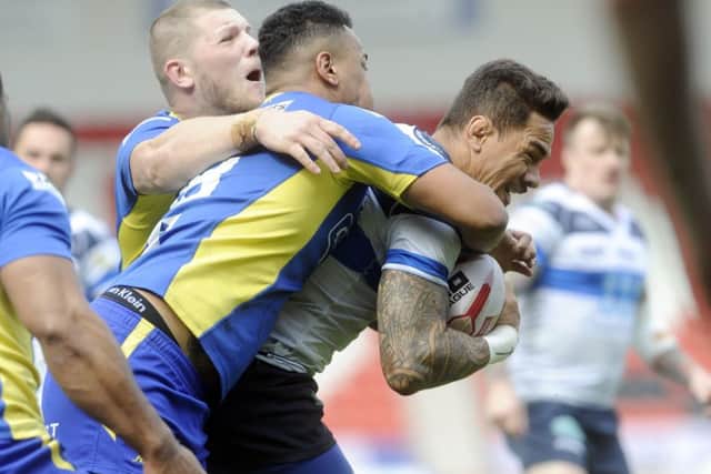 Featherstone's Misi Taulapapa is held by Charlie Martin of Doncaster. PIC: Simon Hulme