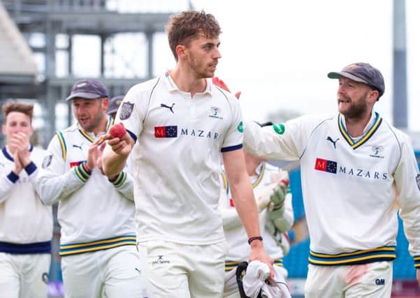 Yorkshire's Ben Coad leads the team off the field after taking 10 wickets in his side's victory over Notts. Picture: swpix.com