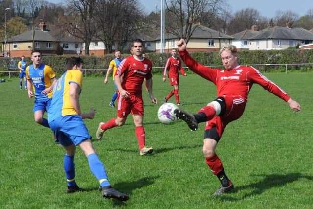 Lew Barnes, of Shire Reserves, beats Horsforth's Declan Broadley to the ball. PIC: Steve Riding