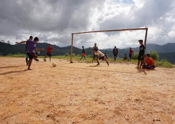 Burmese refugees playing football.