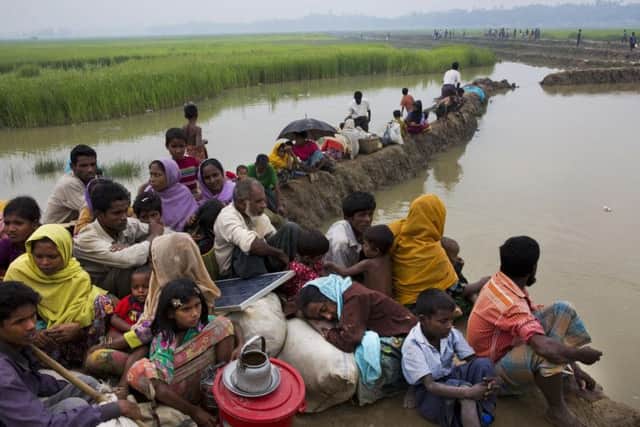 Rohingya Muslims who have fled persecution in Myanmar wait along the border for permission to move further towards refugee camps near Palong Khali, Bangladesh, Thursday, Nov. 2 2017.  (AP Photo/Bernat Armangue)