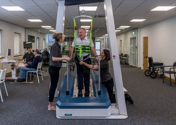 Alf Limb uses the new robotic gait trainer.