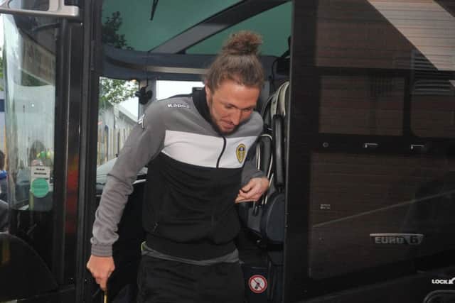 Luke Ayling steps off the coach at Norwich City - but the defender was not included in Leeds United's 18-man squad.