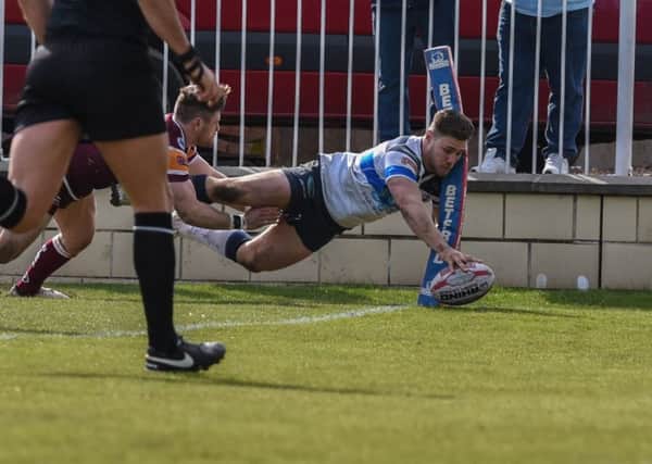 Shaun Robinson dives over for one of his three tries for Featherstone Rovers against Batley Bulldogs. PIC: Dec Hayes