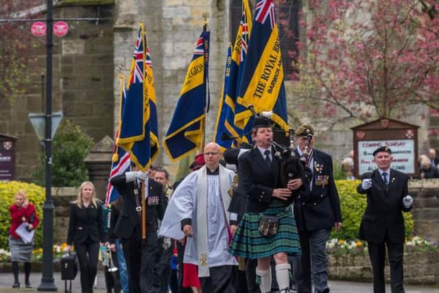 A piper leads the procession from All Saints Church to the maypole and war memorial in Barwick in Elmet. Pictures: James Hardisty
