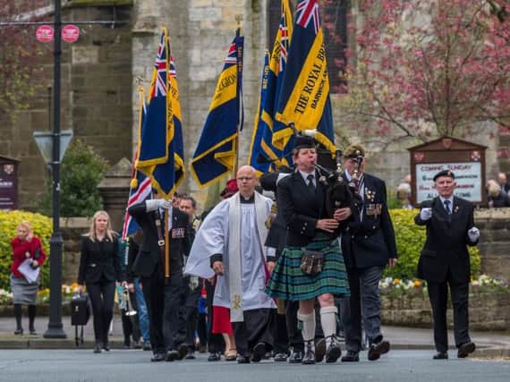 A piper leads the procession from All Saints Church to the maypole and war memorial in Barwick in Elmet. Pictures: James Hardisty
