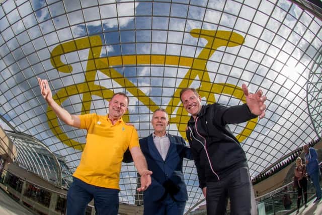 ALL YELLOW: The new vinyl bicycle at Trinity Leeds, unveiled by Sir Gary Verity, shopping centre manager David Maddison and  Christian Prudhomme, Tour de France director.