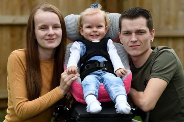 Imogen Holmes pictured with her parents Briony Winstanley and Stephen Holmes.