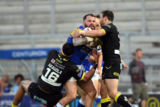 Leeds Rhinos' Adam Cuthbertson is tackled by Warrington's defence. Picture Jonathan Gawthorpe 4th May 2018.