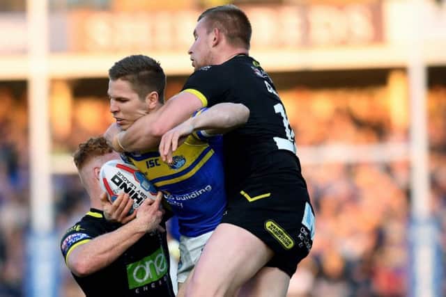TOUGH NIGHT: Leeds Rhinos' Matt Parcell is tackled by Wolves Harvey Livett and Mike Cooper. Picture: Jonathan Gawthorpe