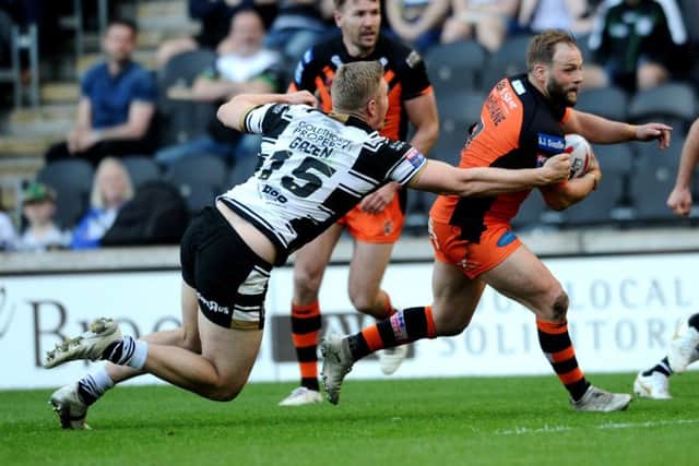 Castleford's Paul McShane is tackled by Hull's Chris Green.