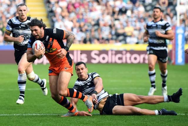 Castleford Tigers' Alex Foster is tackled by Hull's CarlosTuimavave. Picture Jonathan Gawthorpe.