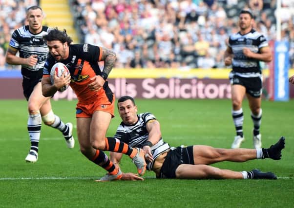 Castleford Tigers' Alex Foster is tackled by Hull's CarlosTuimavave.
 Picture Jonathan Gawthorpe.