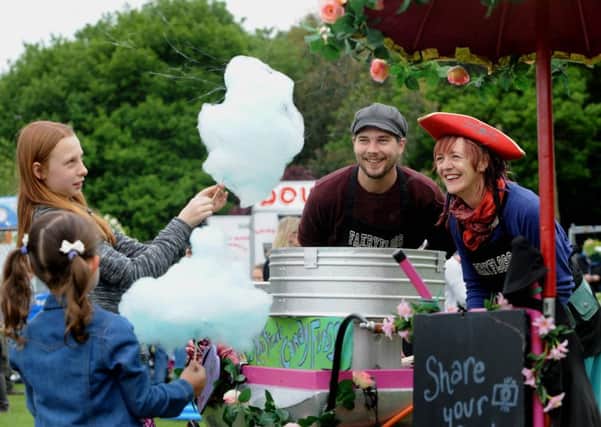 Sara Rushworth and Joe Hogan from Faery Floss serves up candy Floss to children at Meanwood Festival in 2016.
