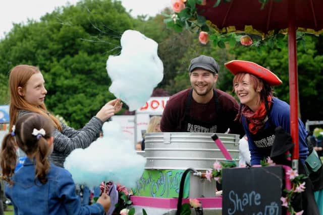 Sara Rushworth and Joe Hogan from Faery Floss serves up candy Floss to children at Meanwood Festival in 2016.