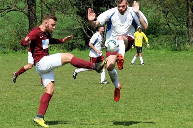 Keelan Milner, left of Pudsey Athetic, and Joel Deacey, of Bardsey, challenge for the ball. PIC: Steve Riding