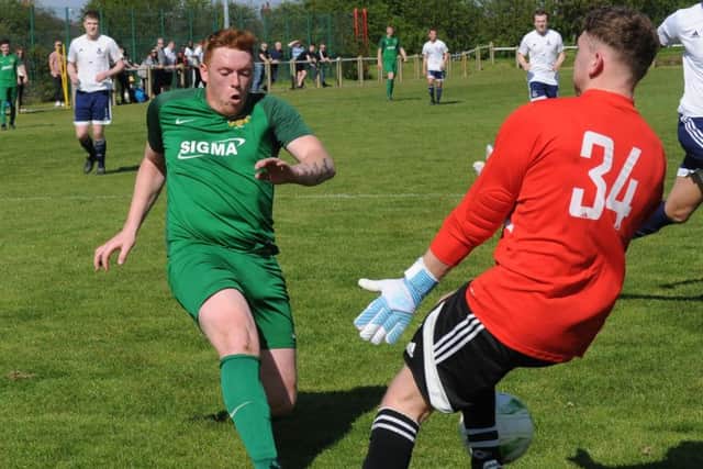Leeds City goalkeeper Dec Flowers closes down James Allan. PIC: Steve Riding