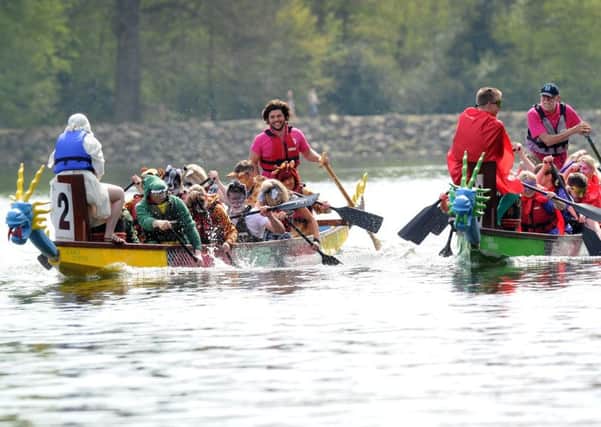 Dragon Boat Race at Roundhay Park, Leeds in 2013.The Gemma Kennealey and Friends Team (left) battle it out with the Optimisa Research team.