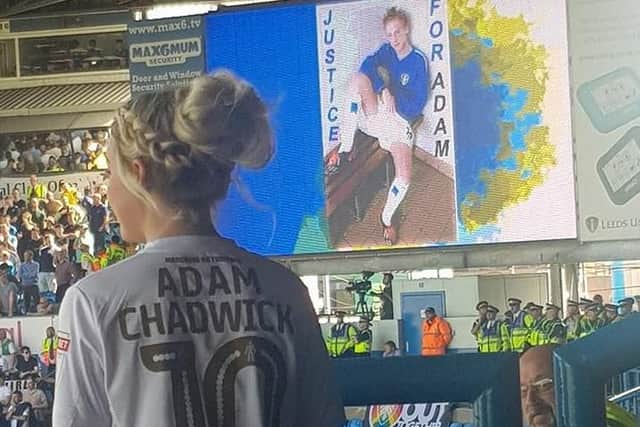 Ruby Chadwick looks out over the crowds as her dad's picture appears on big screens in the ground.