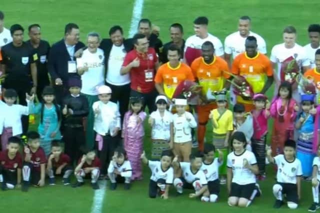 Radrizzani, pictured centre in a red shirt, on the pitch before Leeds' friendly defeat to the Myanmar National League All-Stars yesterday.