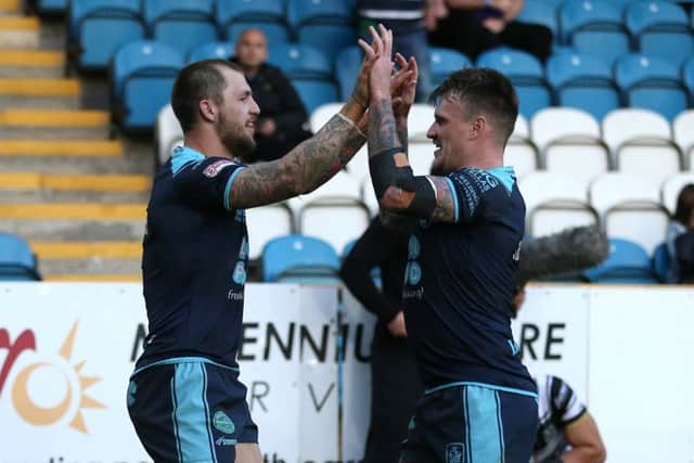 Featherstone Rovers' Luke Briscoe (left) celebrates after scoring his side's second try against Hull.