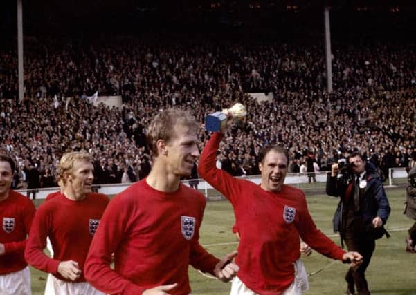Ray Wilson holds the World Cup trophy aloft in 1966.