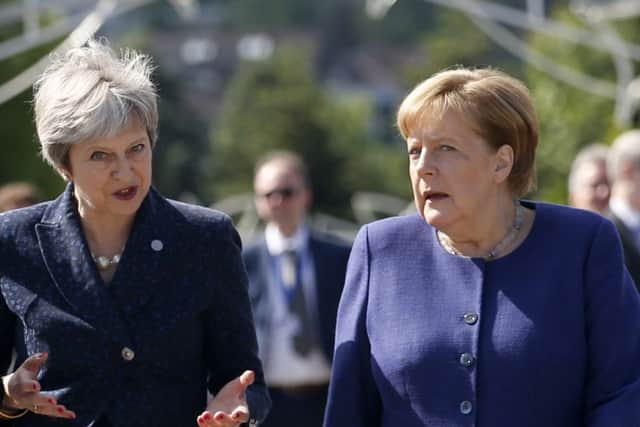Theresa May and Angela Merkel at yesterday's gathering of EU leaders.
