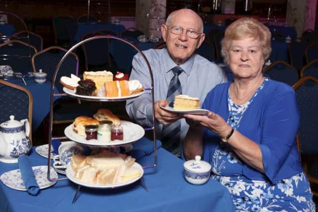 Pictured eating the cake at afternoon tea are Bill and Francis Shane.