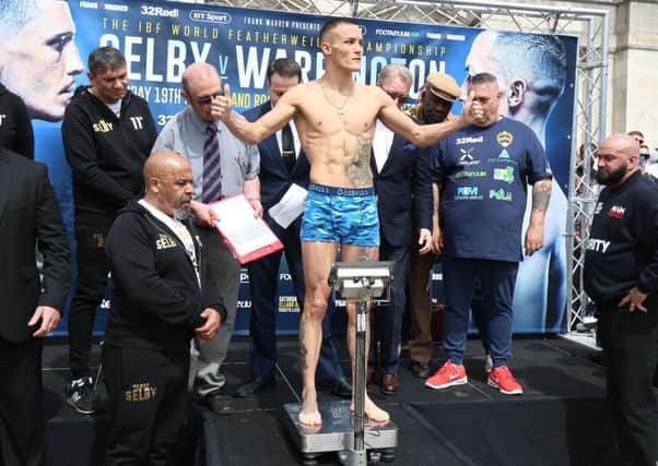 Josh Warrington weighs-in at Leeds Civic Hall yesterday.