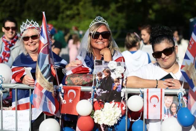 Spectators arrive on the Long Walk ahead of the wedding of Prince Harry and Meghan Markle. PIC: PA