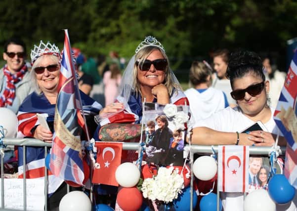 Spectators arrive on the Long Walk ahead of the wedding of Prince Harry and Meghan Markle. PIC: PA