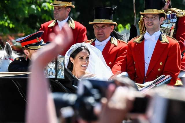 Prince Harry and Meghan Markle wave to crowds on the Long Walk after their wedding in St George's Chapel at Windsor Castle. PIC: PA