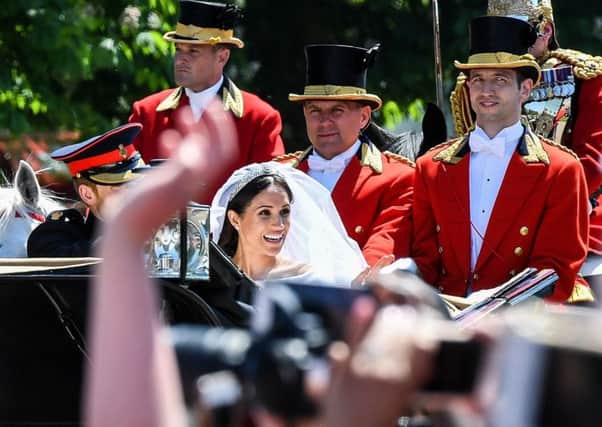 Prince Harry and Meghan Markle wave to crowds on the Long Walk after their wedding in St George's Chapel at Windsor Castle. PIC: PA
