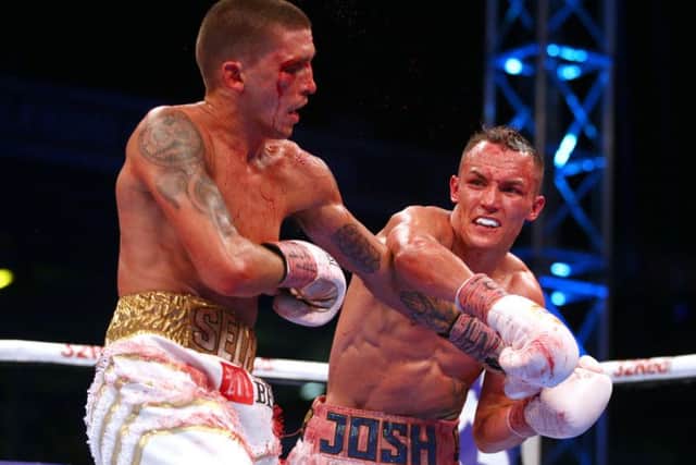 HITTING THE MARK: Josh Warrington connects on Lee Selby with a right hander during their IBF World Featherweight bout at Elland Road. Picture: Dave Thompson/PA Wire