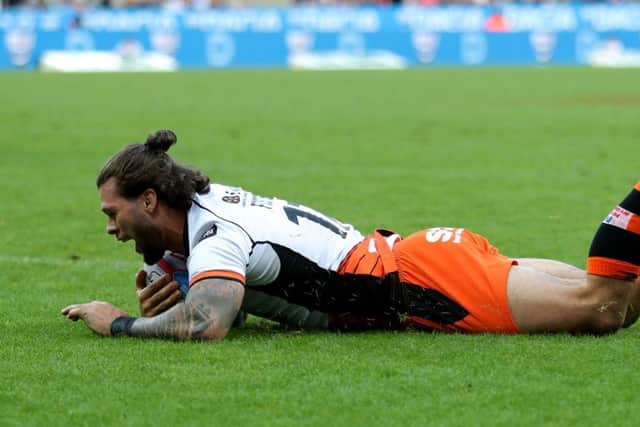 Castleford's Tigers Alex Foster dives in to score against Leeds Rhinos at St James' Park.