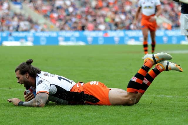 Castleford Tigers Alex Foster dives in to score against former club Leeds Rhinos at St James' Park. PIC: Richard Sellers/PA Wire