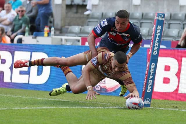 Huddersfield Giants' Darnell McIntosh scores his side's fourth try against Wakefield Trinity in Newcastle.