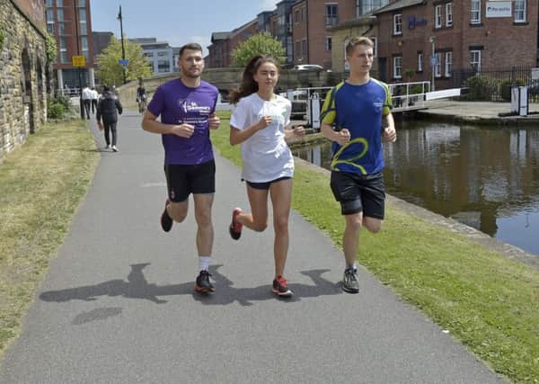 ON A MISSION: Jamie Sheard, left, Lena Hughes and Sam Gibson, right, who will tomorrow set off from Liverpool on their 127-mile journey back to Leeds, in aid of charity.