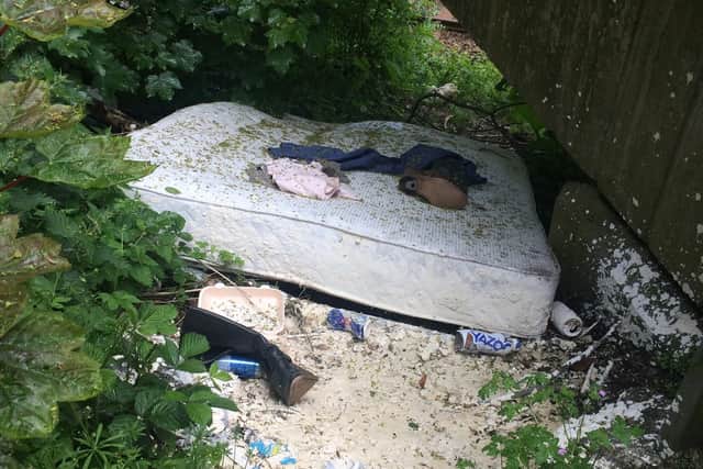 An abandoned mattress and clothes are among the rubbish left behind by fly-tippers. Credit: Coun Richard Cooper
