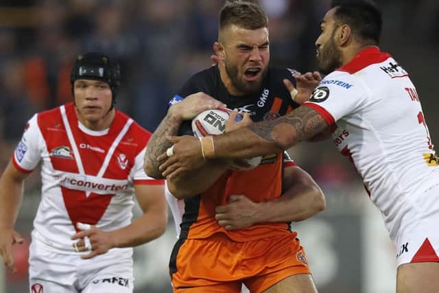 Castleford Tigers' Mike McMeeken is tackled by St Helens' Zeb Taia.